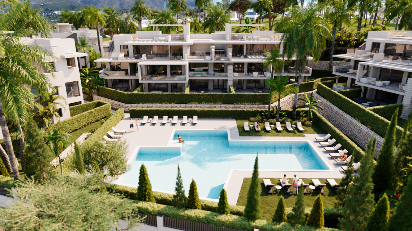 Communal swimming pool with sun loungers surrounded by landscaped gardens